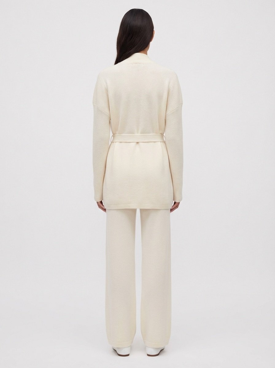 Person wearing a cream-colored Eloise  100% Cashmere Ribbed Cardigan on a white background