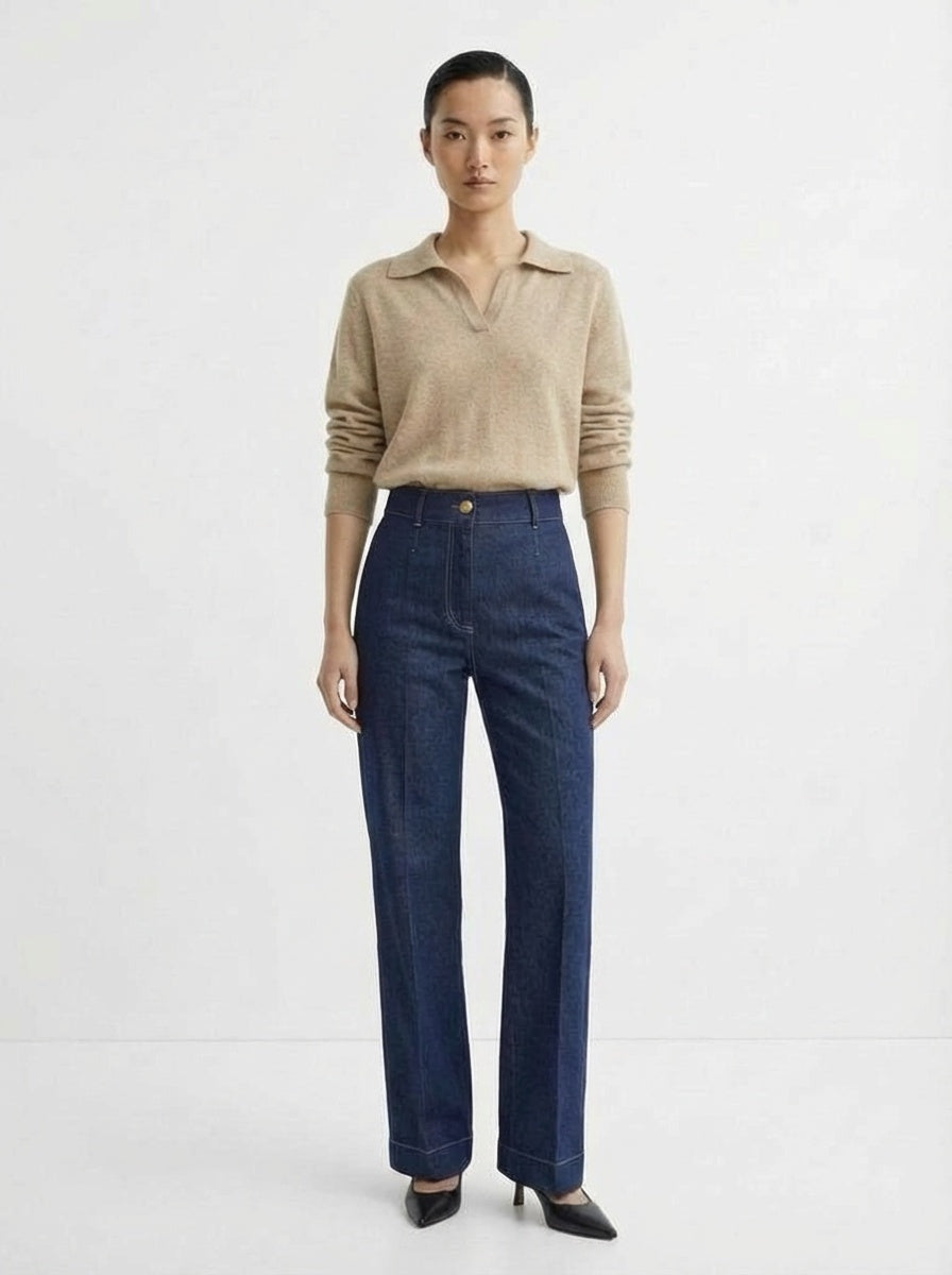 Person wearing a beige Lena 100% Cashmere crew neck sweater and dark blue jeans on a white background